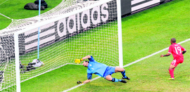 Englands striker Jermain Defoe (R) scores a goal past Slovenias goalkeeper Samir Handanovic during the match between Slovenia and England in Port Elizabeth on Wednesday