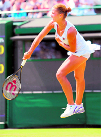 Croatias Karolina Sprem serves to Belgiums Kim Clijsters during the Wimbledon Championships on Wednesday