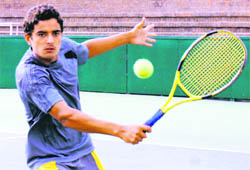 Suraj Beniwal returns a shot during a semifinal match at the CLTA, Sector 10, Chandigarh, on Thursday.