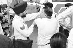 A traffic policeman argues with a Haryana Roadways bus driver during a clash between them on the Chandigarh-Ambala highway at Zirakpur on Thursday.
