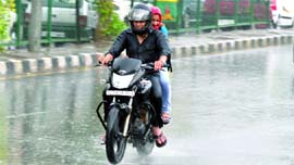 A couple caught in the sudden brief spell of rain in New Delhi on Thursday evening.