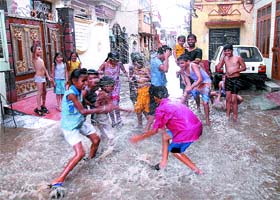 Water Games: Children play with water gathered on the roads after a heavy rain lashed the Jalandhar city