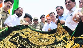 Pakistan Rangers with the chadar they brought for offering at the Baba Chamliyal shrine at the Zero Line border post in the Jammu region on Thursday.