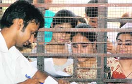 Students submit admission forms at Government College for Women at Parade in Jammu on Thursday.