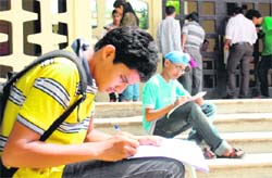 Aspiring candidates for class XI fill the admission forms at Government Model Senior Secondary School, Sector 23, Chandigarh on Friday.