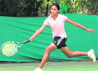 Ashima Garg of the Chandigarh Club Tennis Academy stretches to return a shot against Bhavya Wadawan of the CLTA during the final match of AITA series in Sector 10, Chandigarh, on Friday. 