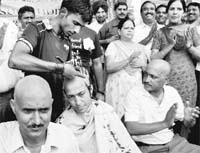 Members of the All-India Passport Employees Association get their heads tonsured to register their protest in Chandigarh on Friday.