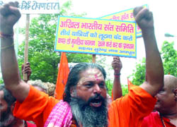 Activists of the Vishwa Hindu Parishad hold a demonstration against the Jammu and Kashmir government and the Centre for imposing toll tax on vehicles ferrying pilgrims to Vaishno Devi and Amarnath shrines in the state, in New Delhi on Friday.