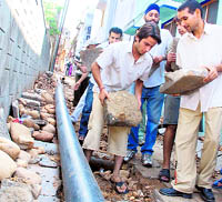 Residents of New Plot ward No. 16 remove floor tiles placed inside the main lane of the locality by the ERA on Friday