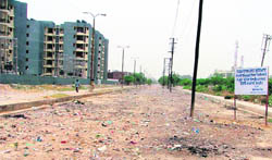 A garbage-strewn shabby stretch of the road from the Sunet railway crossing towards D block at Shaheed Bhagat Singh Nagar colony in Ludhiana. 