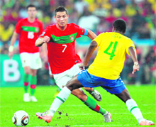 Portugals striker Cristiano Ronaldo (L) fights for the ball with Brazils defender Juan during their World Cup match in Durban