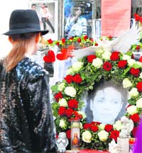 A fan pays a tribute to Michael Jackson at his memorial in Munich. It was MJs first death anniversary on Friday. 