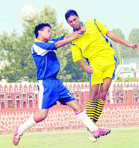 Players in action during the District Football League in Dehradun on Saturday.