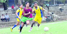 Players vie for the ball at the Lala Nemi Dass Dehradun Football League in Dehradun on Saturday.