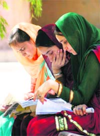 Girls go through their notes before taking the Common Entrance Test at Government College for Women at Gandhi Nagar in Jammu