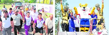 Weight-lifting champion Tara Singh (extreme left) and others run with the Queens baton; and (right) Shera, mascot of the Commonwealth Games, performs bhangra in Ludhiana on Saturday.