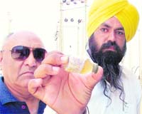 Contaminated water in Shaheed Bhagat Singh Nagar being shown through the PAU water-testing kit; 