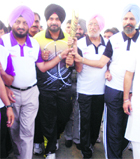 Navjot Singh Sidhu, MP, and others carry the Queens Baton in Patiala on Saturday. 