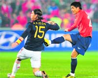 Chiles midfielder Rodrigo Millar (R) scores against Spain as Spains defender Sergio Ramos looks on during their match in Pretoria on Friday