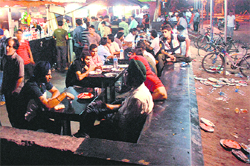 Leftover littered at the night food street, opposite the PGI, as workers at food stalls continue to throw disposable plates and glasses next to the sitting area. 