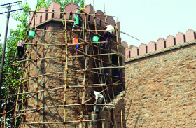 Labourers at work to spruce up Delhi Gate in New Delhi ahead of the Commonwealth Games.