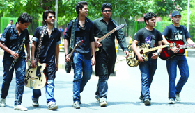 Artistes and members of the Pancham Fan Club on the way to attend a celebration function on the 71st birth anniversary of music composer Rahul Dev Burman at Jantar Mantar in New Delhi on Sunday.