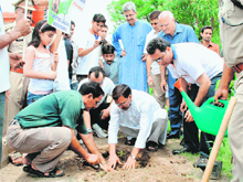 Uttarakhand Agriculture Minister Trivendra Singh Rawat plants a sapling in Dehradun on Sunday. 
