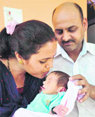 Khem Raj and his wife, Santosh, with the abandoned baby girl at Sunder Bani on Sunday.