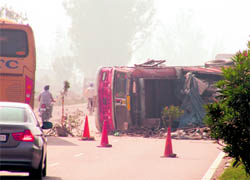 An overturned truck lies on National Highway at Rajpura on Sunday