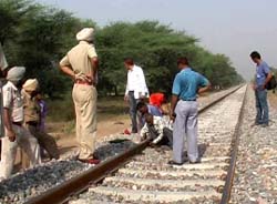 Railway officials carrying out repair work of tracks near Karamgarh Chatra on Sunday morning