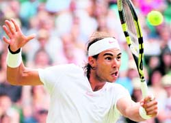 Spains Rafael Nadal returns a ball to German Philipp Petzschner during the Wimbledon Championships in London on Saturday
