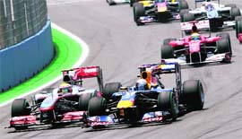 McLaren Mercedes' Lewis Hamilton tries to overtake Red Bull's