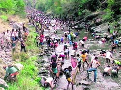 Villagers enjoy fishing at the festival Maund on the Aglar river near Mussoorie on Monday