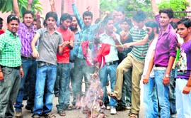 Students of Shravannath Math Jawaharlal Nehru College burn an effigy of the college authorities in Haridwar on Monday