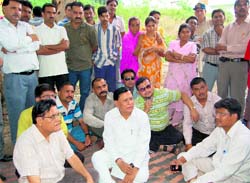Residents of the Sahastradhara Road area hold a protest in Dehradun on Monday