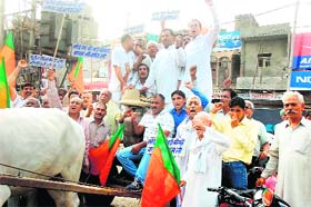 BJP activists take out procession in protest against hike in petro prices in Rohtak