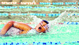 A participant of the Open Swimming competition in action at Ludhiana on Monday.