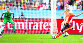 Netherlands striker Arjen Robben (R) scores against Slovakia during their match in Durban on Monday.
