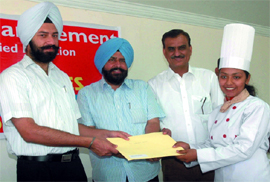 BMC mayor Baljit Singh Birbehman (second from left) and DC Gurkirat Kirpal Singh giving away a certificate to a student of the Institute of Hotel Management in Bathinda on Tuesday