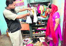 Family members show the almirah from where cash and gold jewellery were stolen at Ram Darbar, Phase II, Chandigarh, on Tuesday