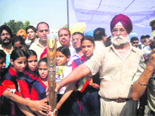 HS Mejie, trustee MBCT, receives the Queen's Baton at Bassi Pathana.