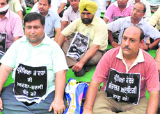 Members of the Recognised & Affiliated Schools Association protest outside the Punjab School Education Board in Mohali.