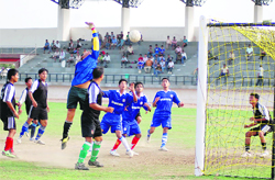 A goalkeeper attempts to save a goal at the District Football League in Dehradun