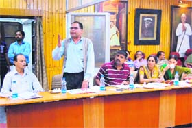 A ward member makes a point at a board meeting of the Nagar Palika in Mussoorie