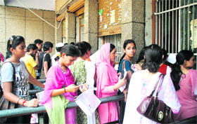 Students queue up outside a counter for purchasing admission forms for postgraduate courses at Jammu University on Tuesday
