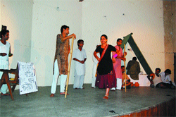 Theatre artistes perform the play Maikoo at the district librarys auditorium. 