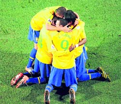 Brazils players celebrate after beating Chile on Monday