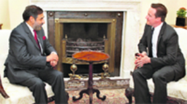 Britains Prime Minister David Cameron speaks to Indias Trade Minister Anand Sharma during their meeting at 10 Downing Street in London