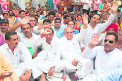 Kalraj Mishra, BJPs national Vice-President, along with state party chief Bishan Singh Chufal, takes part in a dharna against fuel price hike in Dehradun on Wednesday