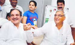 Senior Congress leader Birender Singh in a jubilant mood with Haryana Chief Minister Bhupinder Singh Hooda after filing his nomination for the Rajya Sabha poll at the Haryana Vidhan Sabha in Chandigarh